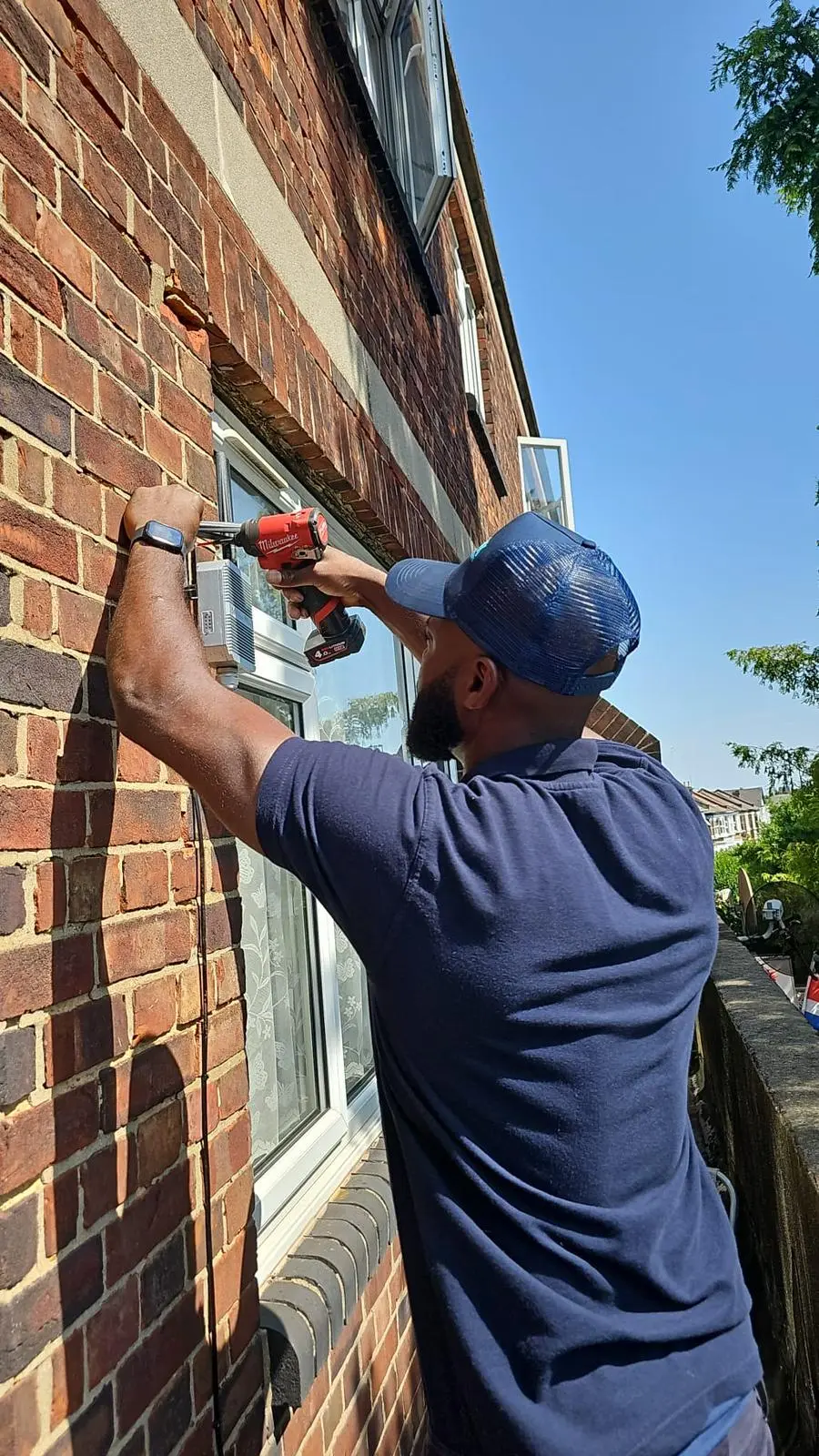 TravHawk engineer installing external broadband equipment on a residential property